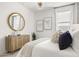 Bright bedroom featuring wood dresser, stylish accents, and chic decor at 15348 W Gray Fox Trl, Surprise, AZ 85387