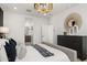 Bright bedroom featuring a neutral color palette, sleek dresser, and ensuite bath at 15348 W Gray Fox Trl, Surprise, AZ 85387