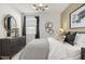 Tastefully decorated bedroom with patterned bedding, modern lighting, and chic accents at 15348 W Gray Fox Trl, Surprise, AZ 85387