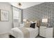 Stylish bedroom featuring patterned wallpaper, soft textures, and elegant lighting at 15348 W Gray Fox Trl, Surprise, AZ 85387