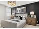 Stylish bedroom featuring a panel accent wall, neutral bedding, and contemporary bedside tables with lamps at 15348 W Gray Fox Trl, Surprise, AZ 85387
