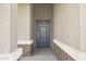 Stylish front entry showcasing a modern door, accentuated by textured walls and elegant brick-style accents at 15348 W Gray Fox Trl, Surprise, AZ 85387