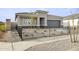 Attractive single-Gathering home with a landscaped front yard, complemented by a black metal fence and a two-car garage at 15348 W Gray Fox Trl, Surprise, AZ 85387