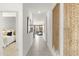 Bright hallway with neutral tones, decorative wall art, and views into the bedroom and living spaces at 15348 W Gray Fox Trl, Surprise, AZ 85387