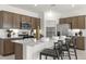 Modern kitchen with island, stylish counter seating, and stainless steel appliances, great for entertaining at 15348 W Gray Fox Trl, Surprise, AZ 85387