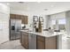 Modern kitchen featuring a large island, stainless steel appliances, and sleek cabinetry for a contemporary feel at 15348 W Gray Fox Trl, Surprise, AZ 85387