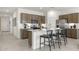 Contemporary kitchen featuring a central island with bar stools, modern appliances, and lots of counter space at 15348 W Gray Fox Trl, Surprise, AZ 85387