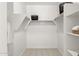 Walk-in closet offers ample storage with shelving and hanging racks, maximizing space at 15348 W Gray Fox Trl, Surprise, AZ 85387