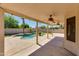 Covered back patio featuring a pool, ceiling fans and string lights at 18207 N 46Th St, Phoenix, AZ 85032