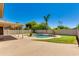Spacious backyard featuring a covered patio with fans and a freeform pool, offering a serene outdoor retreat at 18207 N 46Th St, Phoenix, AZ 85032