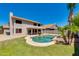 Inviting backyard with a freeform pool, lush lawn, and a covered patio, perfect for outdoor entertaining at 18207 N 46Th St, Phoenix, AZ 85032