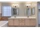 Primary bathroom features a double sink vanity with mirrors and custom lighting above at 18207 N 46Th St, Phoenix, AZ 85032