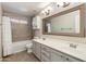 Bright bathroom with a double sink vanity, and tile shower/tub combo at 18207 N 46Th St, Phoenix, AZ 85032