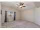 Empty bedroom features neutral walls, carpet, ceiling fan and a window bringing in natural light at 18207 N 46Th St, Phoenix, AZ 85032