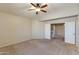 Empty bedroom with carpet, ceiling fan, and access to other rooms of the house at 18207 N 46Th St, Phoenix, AZ 85032