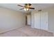 Comfortable bedroom with carpet floors, ceiling fan, closet, and interior door offering accessibility at 18207 N 46Th St, Phoenix, AZ 85032