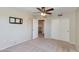 Spacious bedroom with carpet, ceiling fan, lighting, and a closet providing accessibility and comfort at 18207 N 46Th St, Phoenix, AZ 85032