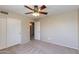 Well-lit bedroom with carpet floors, ceiling fan, closet, and doorway creating an inviting space at 18207 N 46Th St, Phoenix, AZ 85032