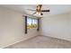 Bedroom featuring a ceiling fan and a window with neighborhood views providing a bright, open feel at 18207 N 46Th St, Phoenix, AZ 85032