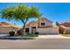 Charming two-story home with a well-manicured front yard and a mature shade tree at 18207 N 46Th St, Phoenix, AZ 85032