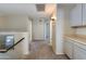 Bright hallway featuring neutral-toned walls and carpet flooring with doors leading to various rooms at 18207 N 46Th St, Phoenix, AZ 85032