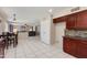 Eat-in kitchen featuring dark wood cabinets, open to the living room, with views to the backyard at 18207 N 46Th St, Phoenix, AZ 85032