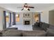 Comfortable living room with a fireplace, ceiling fan, and ample natural light at 18207 N 46Th St, Phoenix, AZ 85032