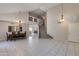 Spacious living room with high ceilings, tile flooring, staircase, and dining area at 18207 N 46Th St, Phoenix, AZ 85032