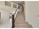 Carpeted staircase with dark wood railing and a white bannister in an open, bright foyer at 18207 N 46Th St, Phoenix, AZ 85032