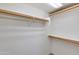 Bright walk-in closet providing generous storage with shelving and wooden rods at 18207 N 46Th St, Phoenix, AZ 85032