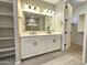 Contemporary bathroom with double sink vanity, a modern shower, and an adjacent walk-in closet at 18871 S 209Th Way, Queen Creek, AZ 85142