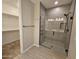 Sleek bathroom showcases a glass shower, and access to a large walk-in closet for ample storage at 18871 S 209Th Way, Queen Creek, AZ 85142