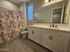 Bathroom features a shower with a decorative floral curtain, a toilet, and a single sink vanity at 18871 S 209Th Way, Queen Creek, AZ 85142