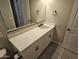 Bright bathroom featuring a white vanity with quartz countertop and black hardware, complemented by a framed mirror at 18871 S 209Th Way, Queen Creek, AZ 85142