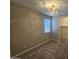 Cozy bedroom featuring a modern light fixture, plush carpet, and a window for natural light at 18871 S 209Th Way, Queen Creek, AZ 85142