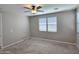 Neutral bedroom featuring a ceiling fan, natural light from multiple windows, and plush carpeting at 18871 S 209Th Way, Queen Creek, AZ 85142