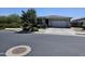 Charming single-story home with a well-manicured front yard and a two-car garage at 18871 S 209Th Way, Queen Creek, AZ 85142