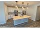 Contemporary kitchen featuring pendant lighting, stainless appliances, white cabinets and an island at 18871 S 209Th Way, Queen Creek, AZ 85142