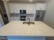 Modern kitchen with white cabinets, stainless steel appliances, and a large center island at 18871 S 209Th Way, Queen Creek, AZ 85142