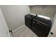 Modern laundry room showcasing sleek black front-load washer and dryer sets at 18871 S 209Th Way, Queen Creek, AZ 85142