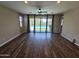 Bright living space with hardwood floors, sliding glass doors to the backyard, and a ceiling fan at 18871 S 209Th Way, Queen Creek, AZ 85142