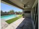 Covered patio has ceiling fan and an outdoor television overlooking the swimming pool at 18871 S 209Th Way, Queen Creek, AZ 85142