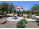 Gathering-friendly playground area with a covered picnic spot surrounded by natural shade and lush greenery at 18871 S 209Th Way, Queen Creek, AZ 85142