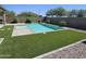 Beautiful pool with artificial turf and desert landscaping, perfect for outdoor entertaining and relaxation at 18871 S 209Th Way, Queen Creek, AZ 85142