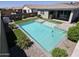 Backyard oasis features a sparkling pool and artificial turf, offering a relaxing and private retreat at 18871 S 209Th Way, Queen Creek, AZ 85142