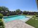 Inviting backyard pool with turf and stone pavers, surrounded by a well-maintained landscape at 18871 S 209Th Way, Queen Creek, AZ 85142