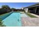 Backyard oasis featuring a sparkling pool, artificial turf, and meticulously landscaped area at 18871 S 209Th Way, Queen Creek, AZ 85142