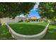 Spacious backyard with lush lawn, a sparkling pool, and a covered patio, perfect for outdoor entertaining and relaxation at 1905 N Calle Maderas --, Mesa, AZ 85213