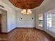 Bright dining room featuring a coffered ceiling, hardwood floors, and modern lighting fixtures at 1905 N Calle Maderas --, Mesa, AZ 85213