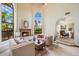 Bright living room featuring high ceilings, large windows, and a cozy fireplace at 1905 N Calle Maderas --, Mesa, AZ 85213